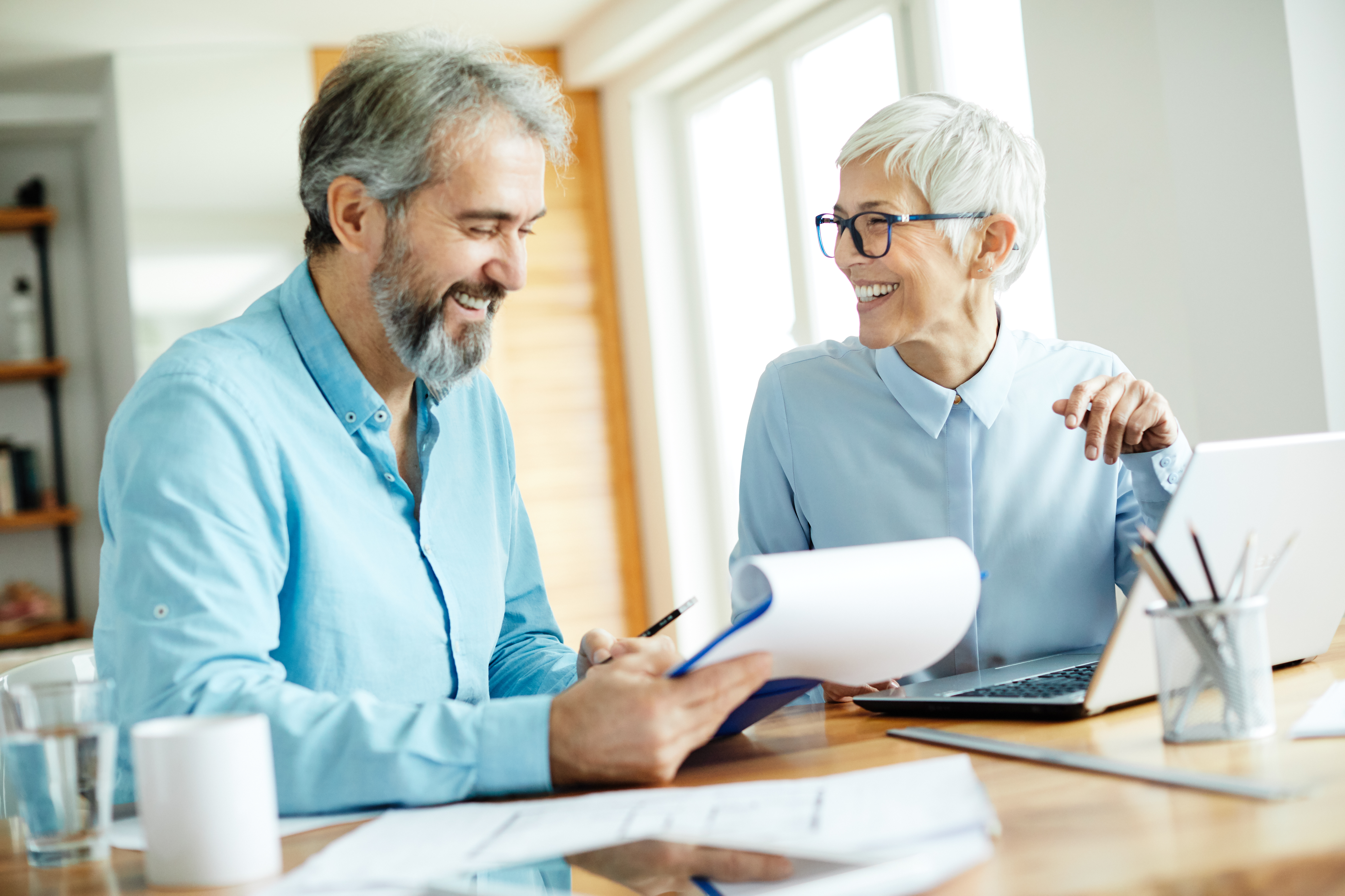 Professional reviewing retirement documents and financial charts representing pension planning advice for high earners and long-term wealth management.